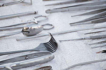 set of old medical instruments clamps ,scalpels and scissors on a white background ,medical practice