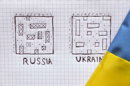 drawing of a children's game sea battle with the text Russia and Ukraine in a notebook, the field of...