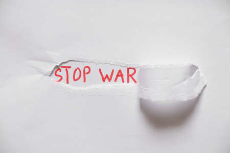 Written text stop war on white paper, protest action, no war between Russia and Ukraine. Stop war,...