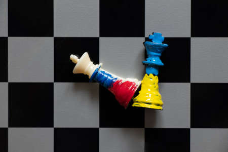 Flags of Ukraine and Russia paint over the chess king of Ukraine against Russia.Chess battles...