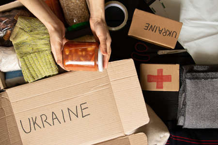 Collecting a humanitarian food set to help people who suffered during the war at the hands of...