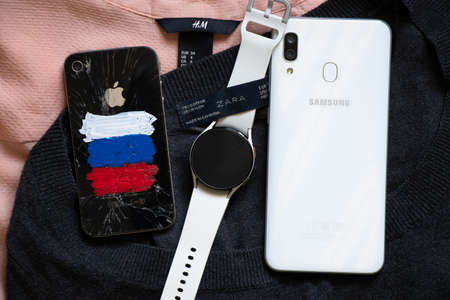 Ukraine Dnepr 03/09/2022 - iPhone 4 with a painted Russian flag and ZARA and H and M brand goods, as well as a Samsung phone and watch, sanctions in Russia, Russia's war against Ukraineのeditorial素材