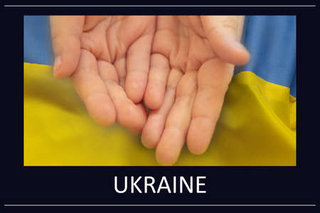 A little girl stretched out her hands on the background of the national flag of Ukraine and next to the text Ukraine, stop the war in Ukraine, peaceful peopleの写真素材