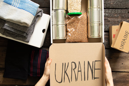 Collecting a humanitarian food set to help people who suffered during the war at the hands of Russia, stop the war in Ukraine, humanitarian aid 2022の写真素材