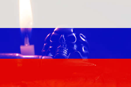 Flag of Russia and a skull near a candle. War in Ukraine. Stop war and peace in Ukraine. Death of...