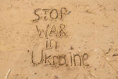 Stop war in Ukraine written on the sand on the banks of the Dnieper River in Ukraine, a protest 2022の写真素材