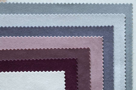 A palette of velor soft fabric in different colors for furniture upholstery as a background...