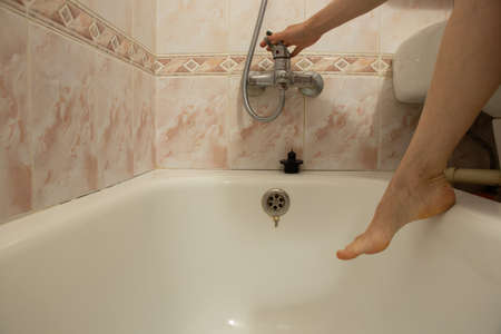 Women's feet in the bathroom, bathing in the bathroom at home, hygieneの写真素材