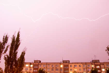 Lightning at night with heavy rain and thunder over Ukraine, lightning over the city in the night sky over the houseの写真素材