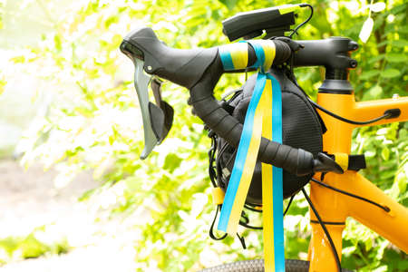 Flag of Ukraine tied to the steering wheel of a sports bike on the street in Ukraine, patriot, urban...