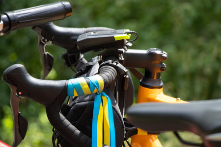 Flag of Ukraine tied to the steering wheel of a sports bike on the street in Ukraine, patriot, urban...