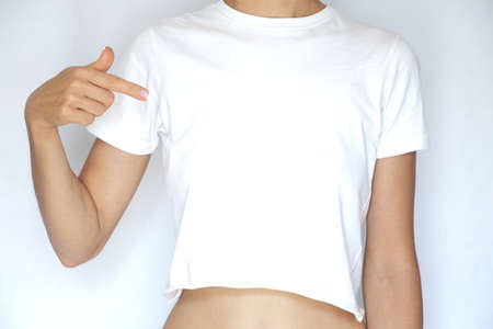 A girl in a white t-shirt on a white background, a place for text, a women's t-shirt on a white, a clothing storeの写真素材