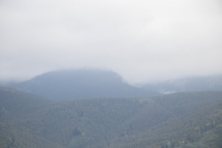 Carpathians view from the mountain to the Carpathian ranges in autumn, clouds in the sky over the...