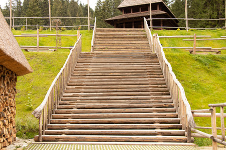 Wooden steps and a wooden house in the mountains in the Carpathians in Ukraine, wooden stairs to the topの写真素材