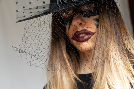 The image of a witch, witch makeup on the face of a girl and a hat of a witch, Halloween, a portrait...