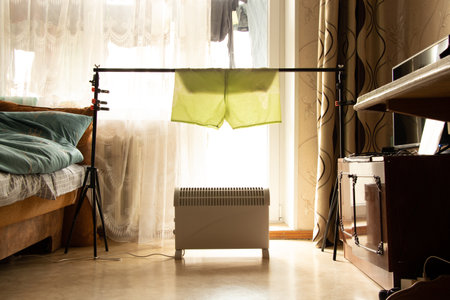 Dry the shorts on the photo gate above the convector in the apartment, dry the washed things in the...