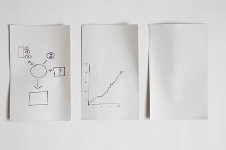 The graph is drawn by hand on white paper on a white background. Place for text and cards, plan and statistics for business as a background.Statisticsの写真素材