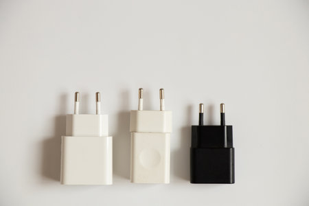 Charging blocks for the phone lie on a white background close-up, three power suppliesの写真素材