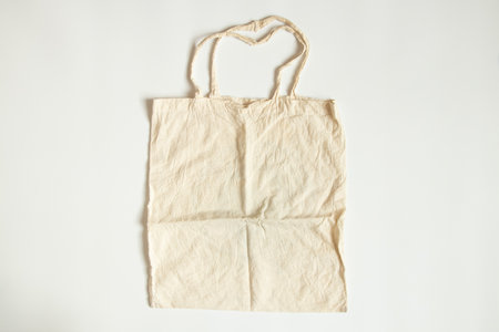A fabric beige bag lies on a white background, a grocery bagの写真素材