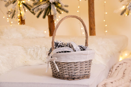 Christmas cones lie in a New Year's basket near the Christmas tree at home, New Year's holidayの写真素材
