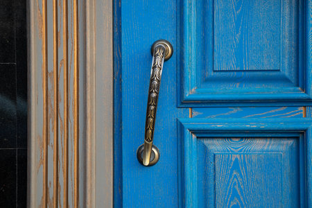 door handle on an old blue door on a residential buildingの写真素材