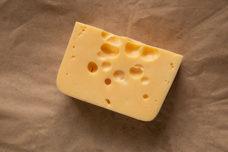 piece of cheese with holes on isolated background close up