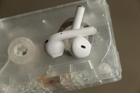 old music cassette and wireless headphones on an isolated backgroundの写真素材