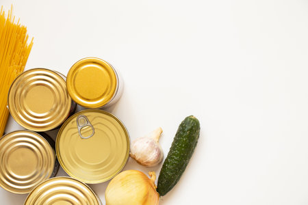 Canned food different, spaghetti and onion, cucumber and garlic on a white background, a set of products lies on a whiteの写真素材