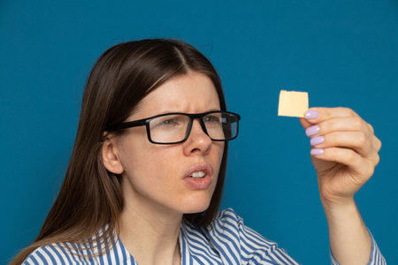 The girl looks at a small paper card, readの写真素材