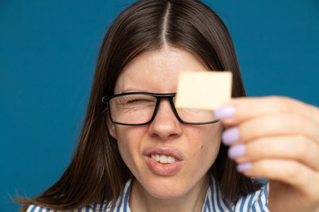 The girl looks at a small paper card, readの写真素材