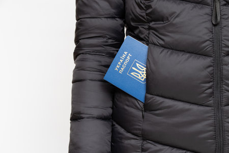 Ukrainian foreign biometric passport in the pocket of a black women's jacket on a white background, Ukrainianの写真素材