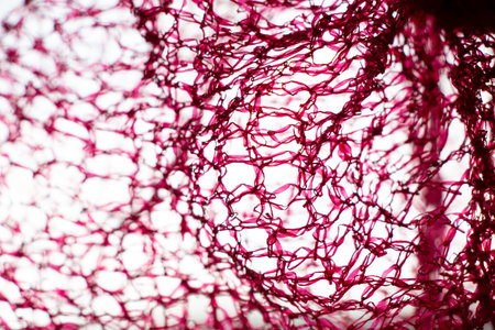 Red grid as background on light and shadow close-up