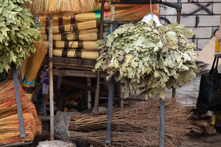 brooms on a window at a bazaar in the city of Dniproの写真素材