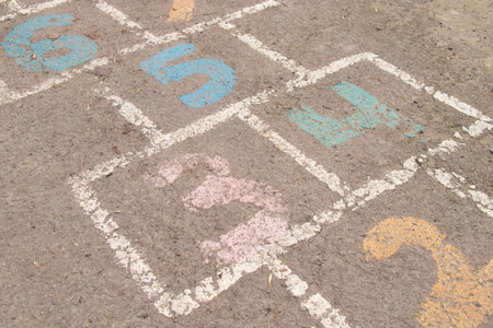 children's game on the asphalt, numbers are painted on the asphalt with paintの写真素材