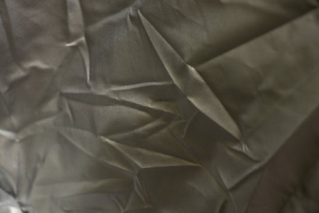gray fabric crumpled gloss as a backgroundの写真素材