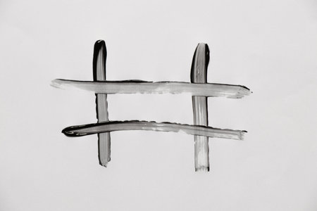 Hashtag lattice icon drawn with black paint on white paperの写真素材
