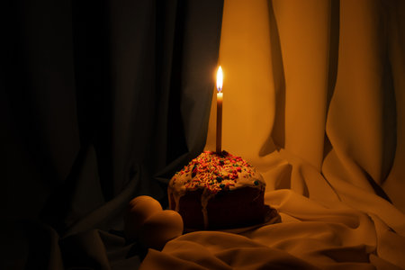 Candle in Easter cake, against the background of the flag of Ukraine, Easter holiday in Ukraine 2023の写真素材
