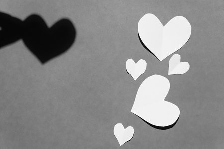 cut out of paper heart lies on paper, valentine, black and white photoの写真素材