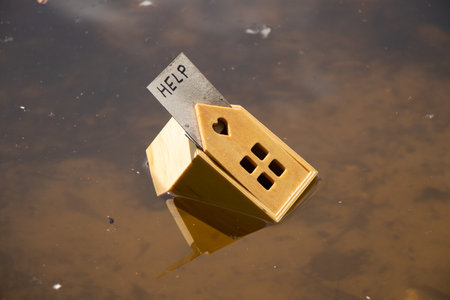 A small wooden house floats on the Dnieper in Ukraine and a paper card on the roofs of the house...