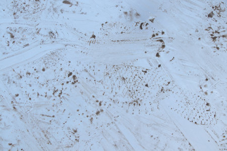 metal gray plate on the road in footprints from shoes as backgroundの写真素材
