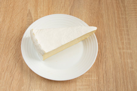 sliced brie cheese close-up on the tableの写真素材