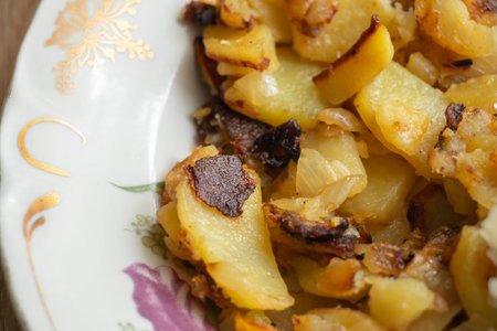 fried potatoes with cabbage in a plate on the table close-upの写真素材