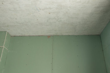 green drywall wall in the room during renovation, apartment renovation, gypsum plasterboard as a backgroundの写真素材