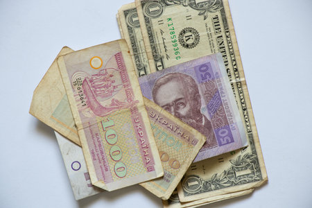 fifty hryvnia one dollar and old paper coupon of the first Ukrainian money on a white background,...