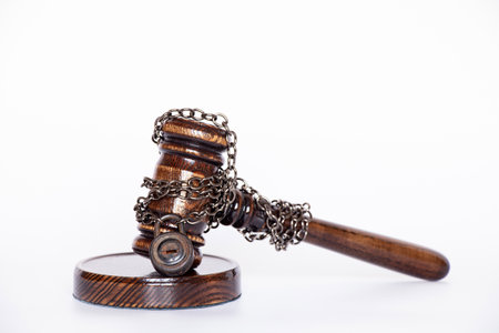 The judge's gavel is tied with a chain to the padlock on white background, not the legality of the...