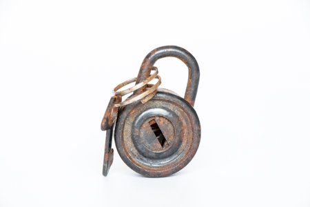 Small black round padlock on a white background close-upの写真素材