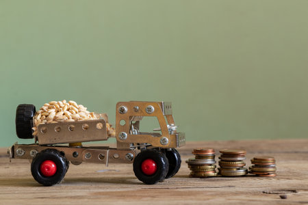 Cargo transportation of grain on a childrens typewriter from a metal constructor on a wooden board...