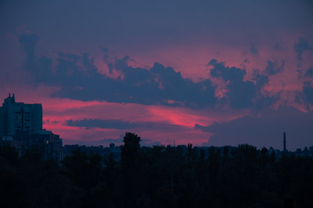 The city of Dnipro in the evening at sunset and pink sky in Ukraine, sunset in the cityの写真素材