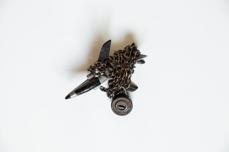 Children's plastic plane on a chain under a padlock on a white background, sanctions and a ban on flightsの写真素材