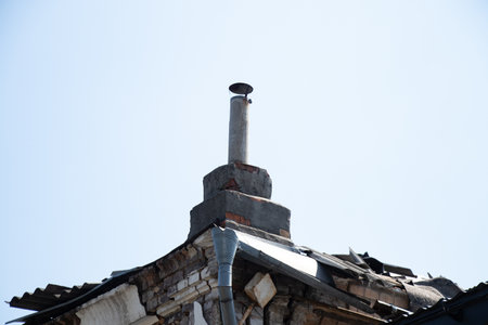 Roof and chimney on an old abandoned derelict house against the sky in Ukraine in the city of Dniproの写真素材